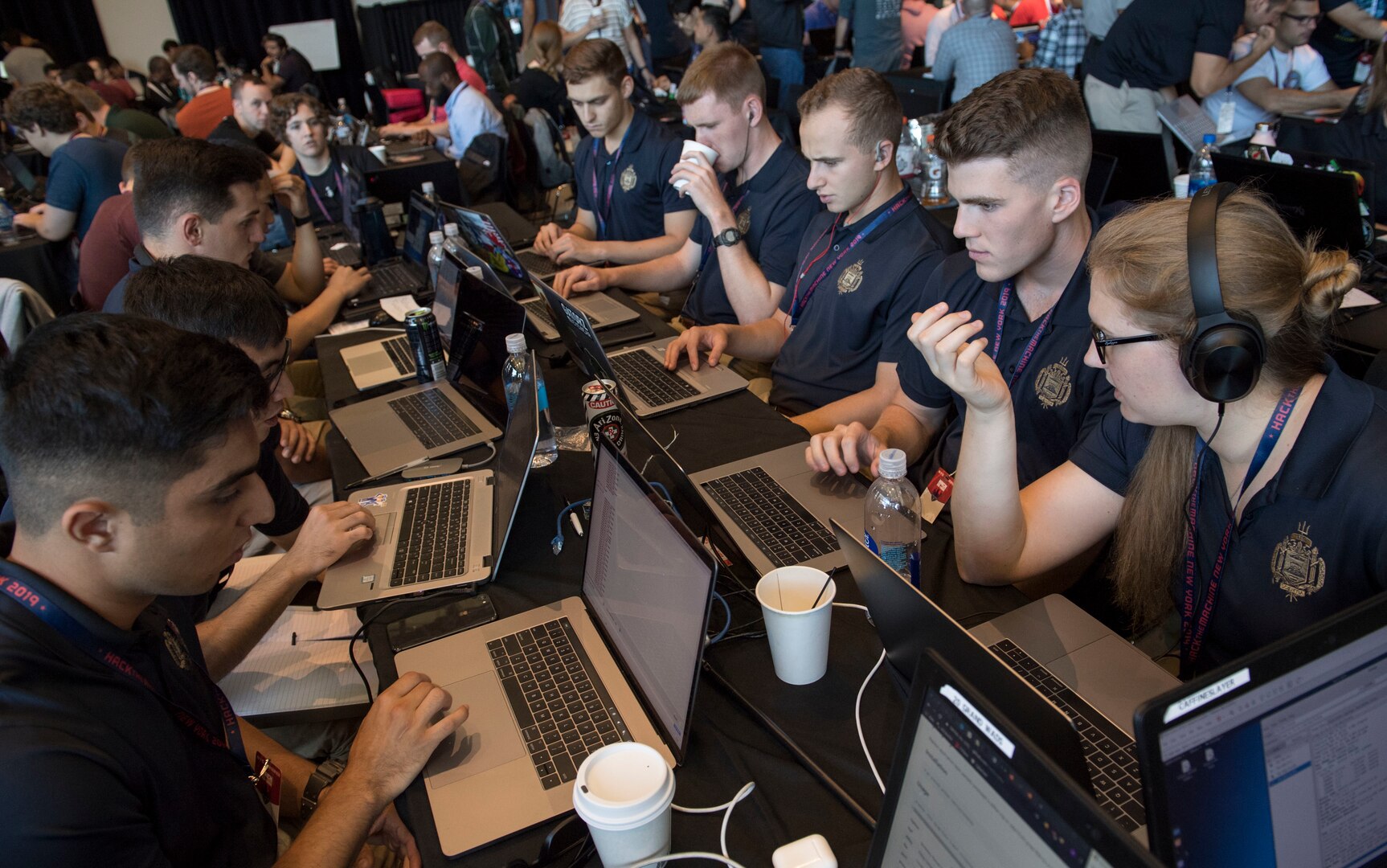 A team of Naval Midshipmen and Air Force Airmen from the Naval Academy and Air Force Academy participate in track one during HacktheMachine competition at the Brooklyn Navy Yard in New York City, Sept. 7, 2019.