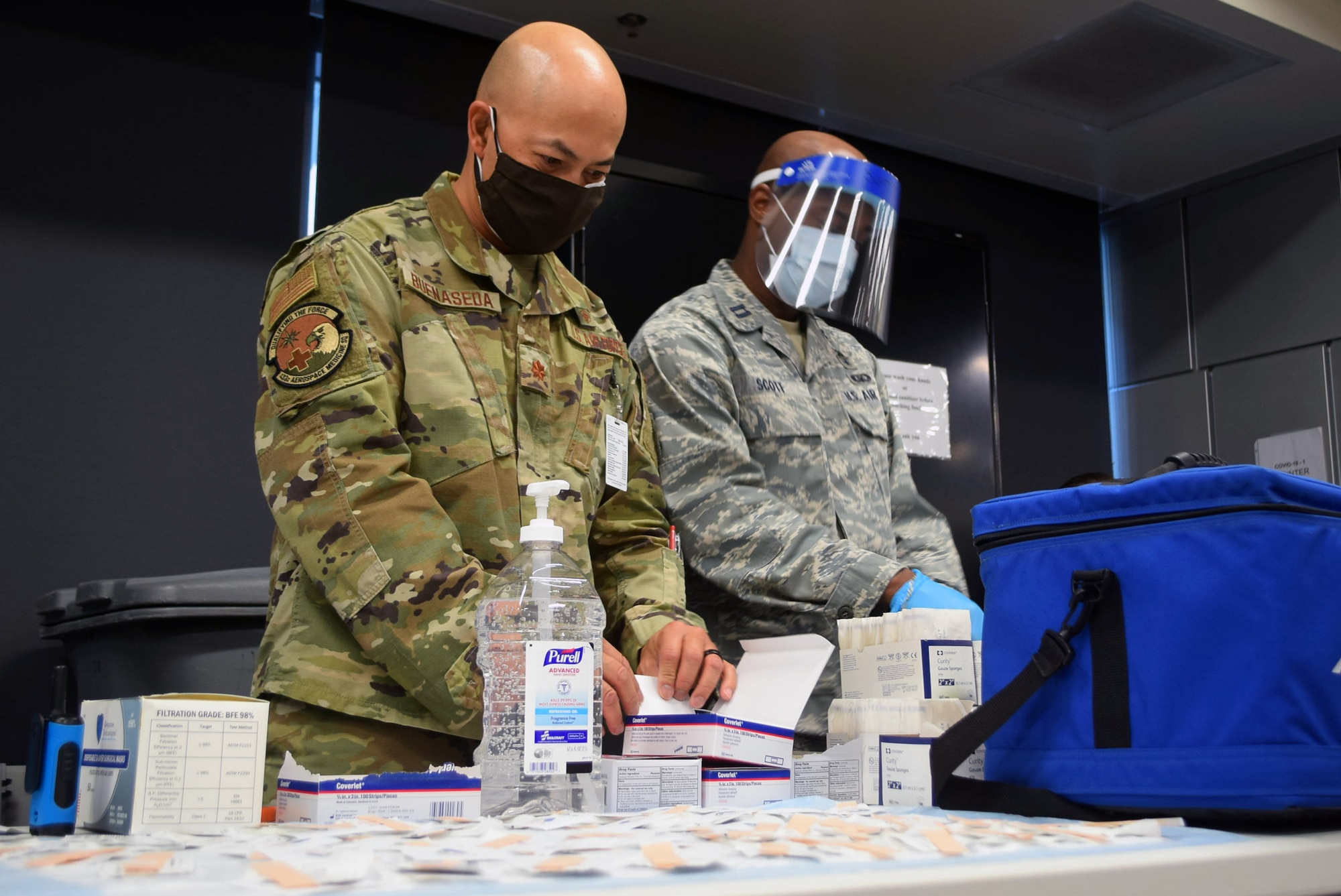 Maj. Jerry Buenaseda, 433rd Aerospace Medicine Squadron clinical nurse, and Capt. Albert Scott Jr., 433rd Medical Squadron critical care nurse, prepare to distribute the COVID-19 vaccine to 433rd Airlift Wing members at Joint Base San Antonio-Lackland, Texas March 7, 2021. The COVID-19 vaccination rollout took a year in planning, strategizing, and training personnel. (U.S. Air Force photo by Tech Sgt. Mike Lahrman)