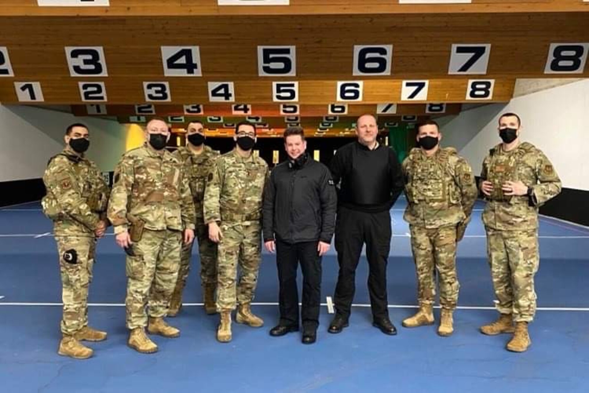 Airmen from the 422d Security Forces Squadron pose for a photo along with instructors from the Northamptonshire Police Department, Mar. 5, 2021.  Airmen from the 422d SFS utilized the NHPD firing range to help strengthen their tactics and techniques. Events like this help strengthen the local partnership between the 422d SFS and the NHPD. (U.S. Air Force photo by Staff Sgt. Carlos Sandoval)