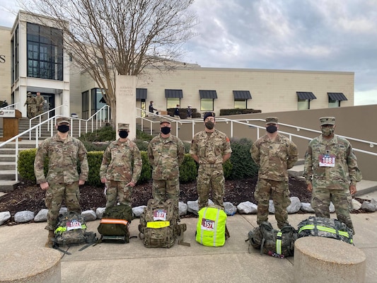 U.S. Army Engineer Research and Development Center Soldiers Capt. Jeremiah Paterson, ERDC Commander Col. Teresa Schlosser, Maj. Earl Dean, British Liaison Maj. Peter Mackintosh, Capt. Patrick Border and Lt. Col. Christian Patterson rally with 25-pound ruck sacks in advance of the 18.6-mile Norwegian Foot March at Camp Shelby Joint Forces Training Center, near Hattiesburg, Miss., March 6, 2021. (U.S. Army Corps of Engineers photo)