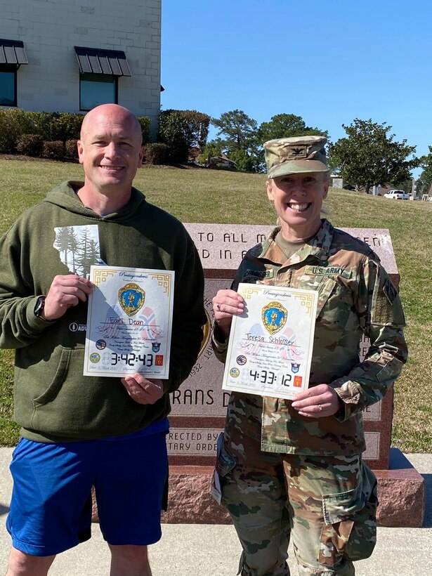 U.S. Army Engineer Research and Development Center Commander Col. Teresa Schlosser and Maj Earl Dean hold certificates recognizing their exceptional completion times during the 18.6-mile Norwegian Foot March at Camp Shelby Joint Forces Training Center, near Hattiesburg, Miss., March 6, 2021. Schlosser, Dean and four additional ERDC Soldiers, including Lt. Col. Christian Patterson, British Liaison Maj. Peter Mackintosh, Capt. Patrick Border and Capt. Jeremiah Paterson, completed the event. (U.S. Army Corps of Engineers photo)
