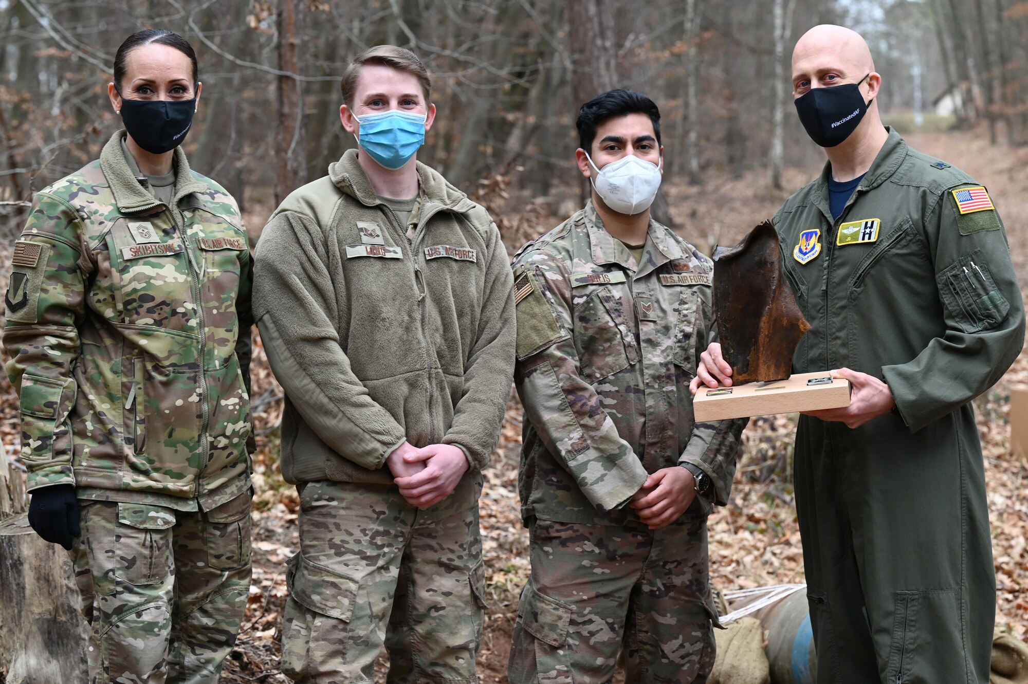 U.S. Air Force Brig. Gen. Josh Olson, 86th Airlift Wing commander, and 86th AW Command Chief Master Sgt. Hope Skibitsky pose for a photo with Airmen assigned to the 786th Civil Engineer Squadron’s Explosive Ordnance Disposal Flight during a EOD demonstration