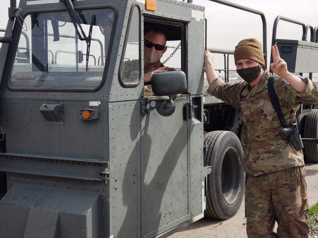 Senior Master Sgt. Benjamin Seekell (seated) conducts familiarization training on a cargo loader with Senior Airmen Kevin Linder from a deployed location in Iraq. CONTRIBUTED PHOTO
