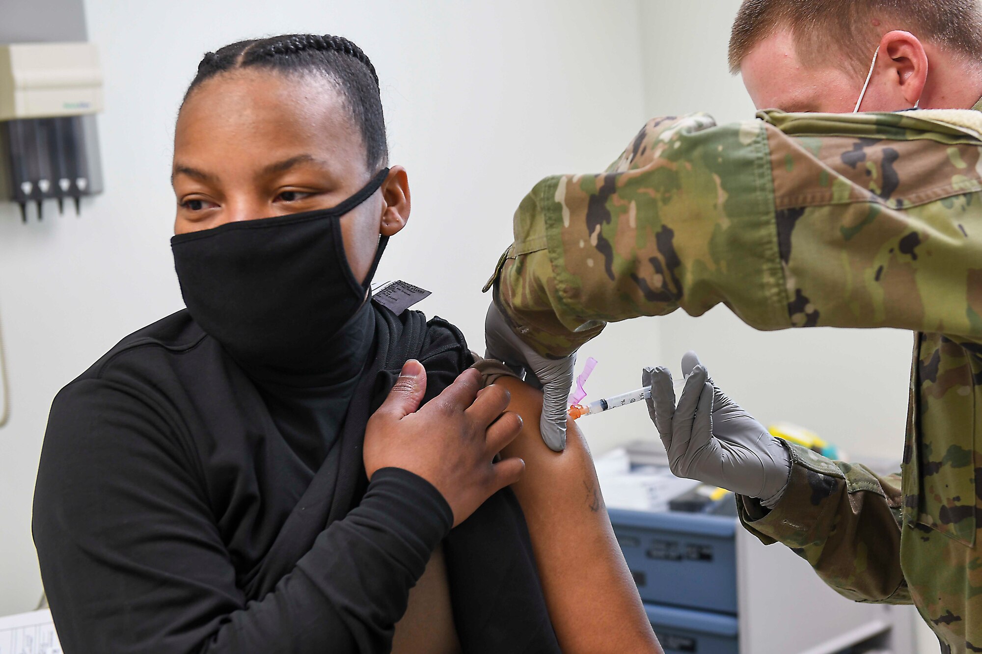 CHINHAE, Republic of Korea (Jan. 8, 2021) Spc. William Hunter, right, administers the COVID-19 vaccine.