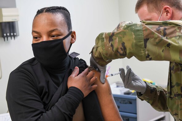 CHINHAE, Republic of Korea (Jan. 8, 2021) Spc. William Hunter, right, administers the COVID-19 vaccine.
