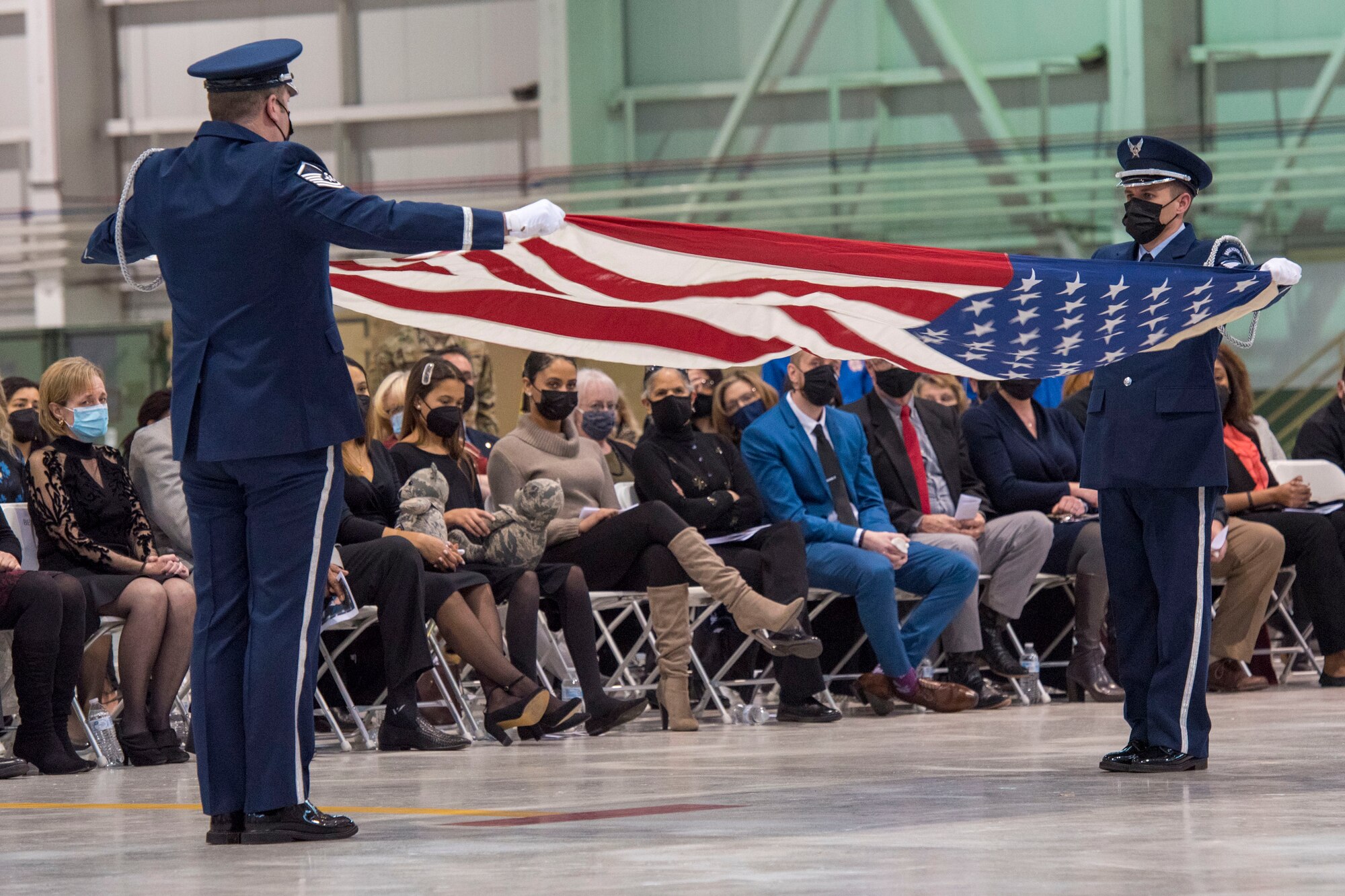 167th Airlift Wing base honor guard members, Master Sgt. Justin Bird and Tech. Sgt. Travis Hall perform a flag folding during a memorial service held at the 167th Airlift Wing, Shepherd Field, Martinsburg, West Virginia, March 6, 2021. Three American flags were presented to Young’s family during the service.