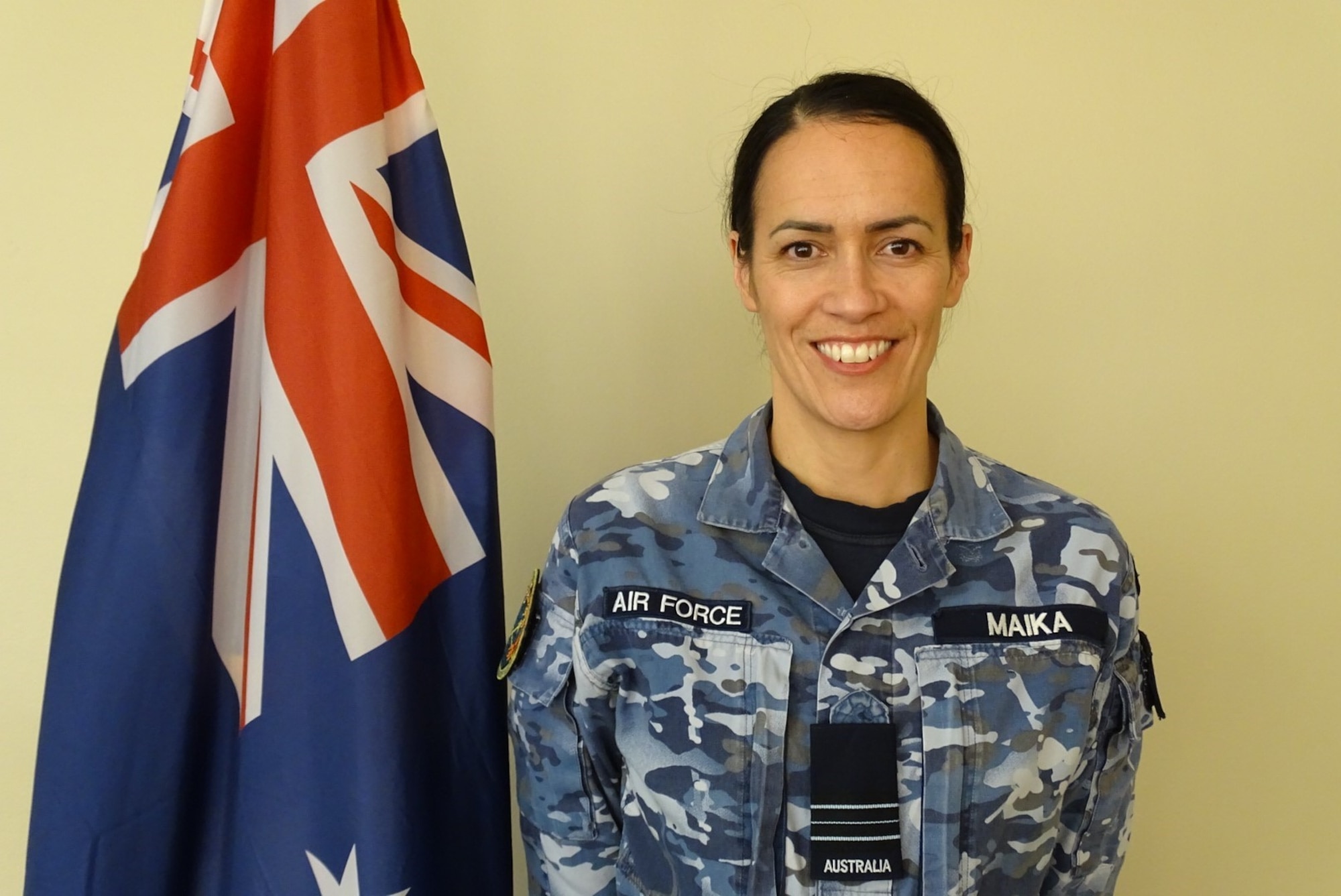 Photo of Royal Australia Air Force Squadron Leader Jaimee Maika with Australian Flag