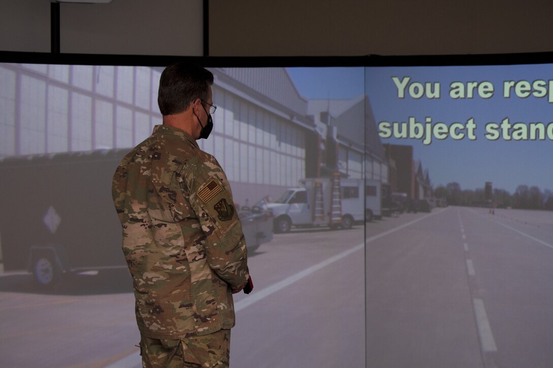 Lieutenant Col. Mark Thomas, 916th Mission Support Group commander, advances through a simulation in the MILO Firearms Training Simulator recently purchased by 916SFS using Squadron Innovation Funds.