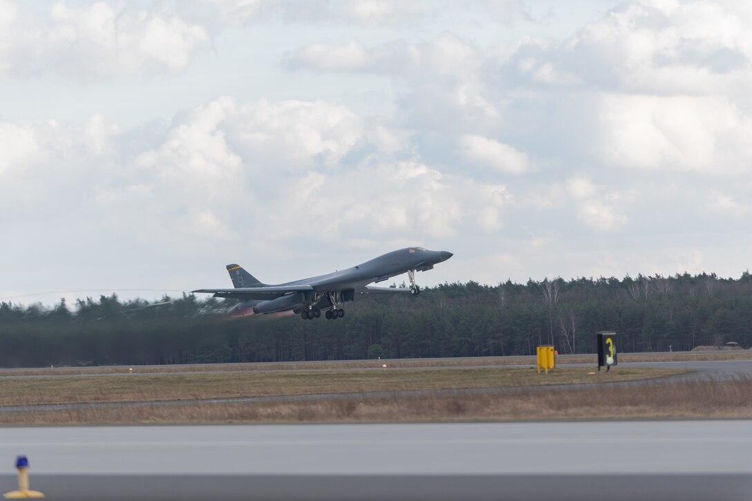 A U.S. Air Force B-1B Lancer aircraft departs after a hot-pit refuel at Powidz Air Base, Poland, March 12, 2021. Hot-pit refueling allows for rapid refueling while aircraft engines are still running and the aircrew inside, ensuring aircraft return to the air as quickly as possible. This operation allowed the Bomber Task Force to practice elements of Agile Combat Employment while continuously delivering airpower alongside allies and partners. (U.S. Air Force photo by Senior Airman John R. Wright)