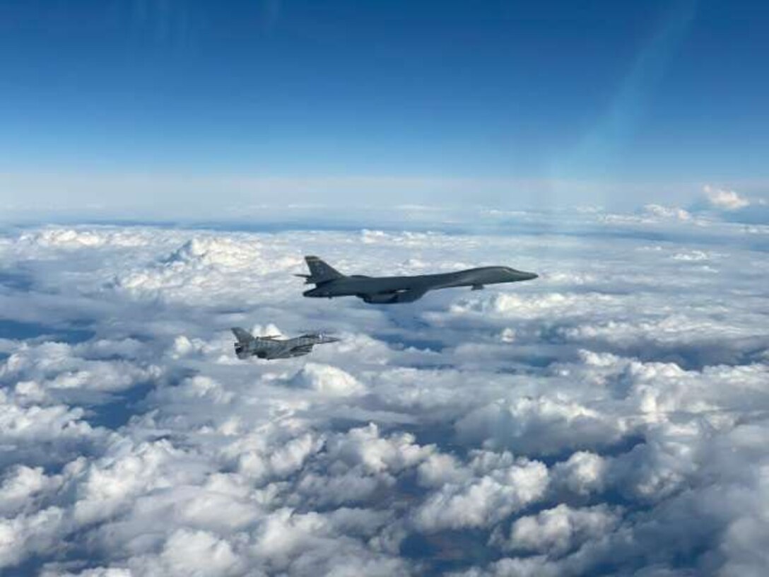 A Polish F-16 Fighting Falcon flies alongside a B-1B Lancer during a Bomber Task Force Europe Mission, March 12, 2021. During the mission, B-1s integrated with Polish, Danish and Swedish fighters, demonstrating the U.S.' commitment to its allies and partners.