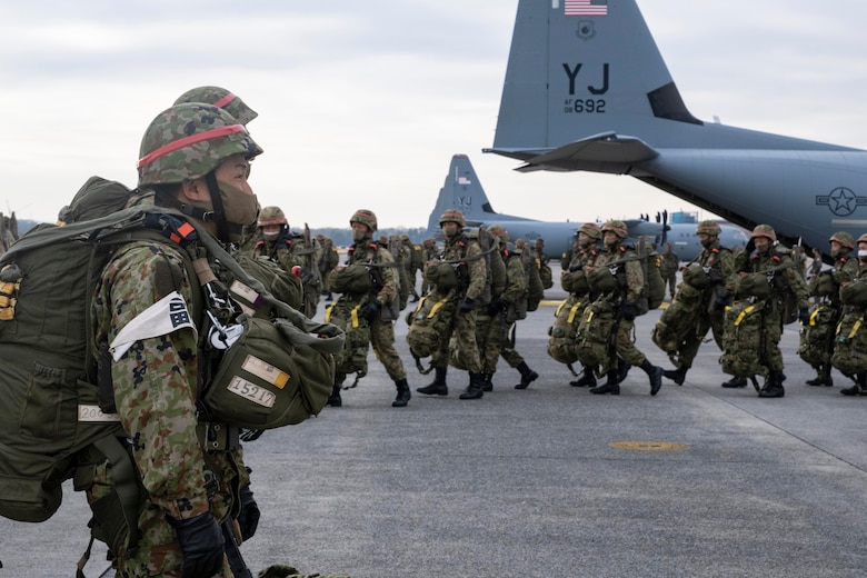 Japan Ground Self Defense Force paratroopers line up to load onto a C-130J Super Hercules, assigned to the 374th Airlift Wing, during exercise Airborne 21 at Yokota Air Base, Japan, March 9, 2021.
