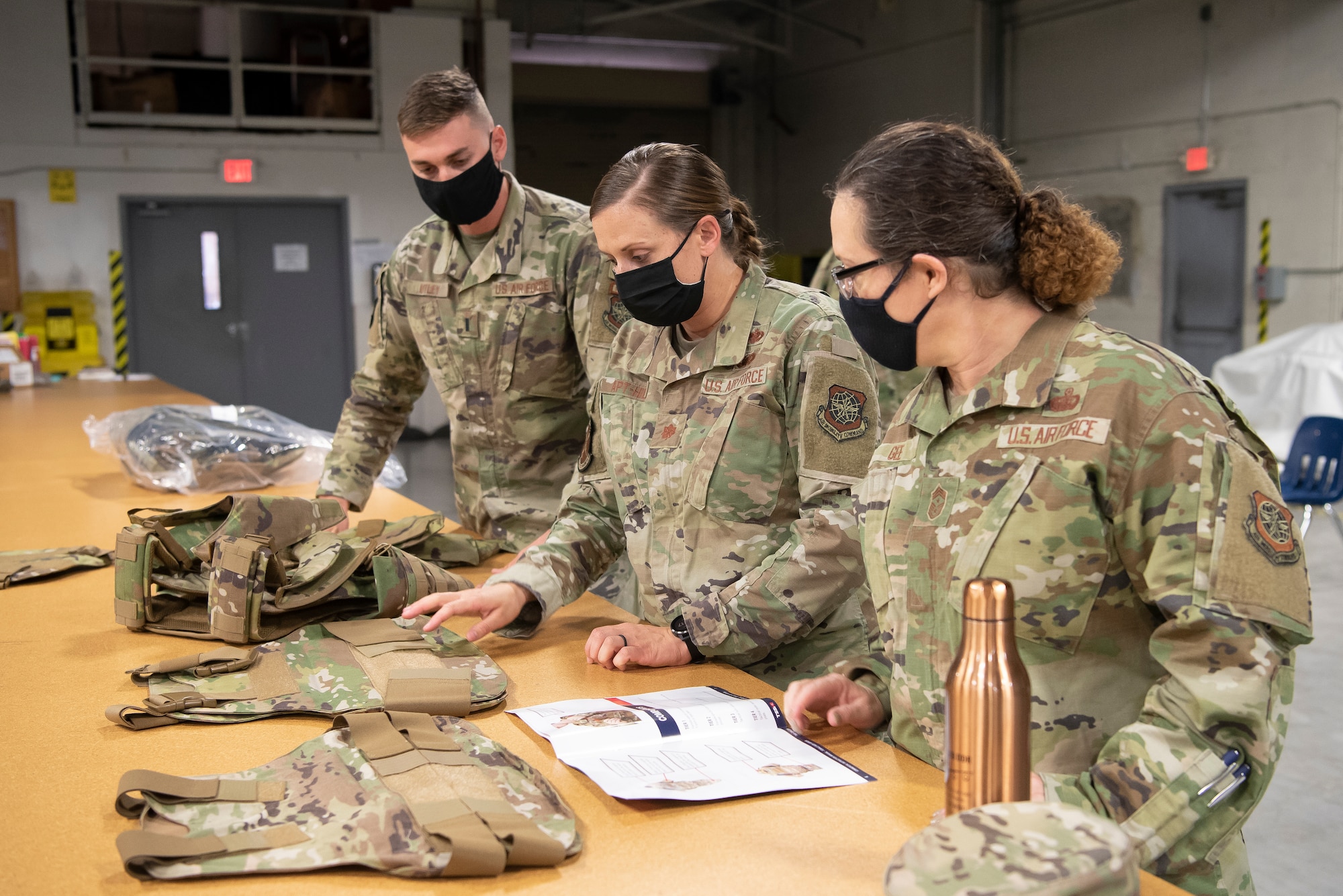 6th Air Refueling Wing command chief, Chief Master Sgt. Shae Gee (right), learns about the new female Improved Outer Tactical Vest at MacDill Air Force Base, Fla., Feb. 17, 2021.