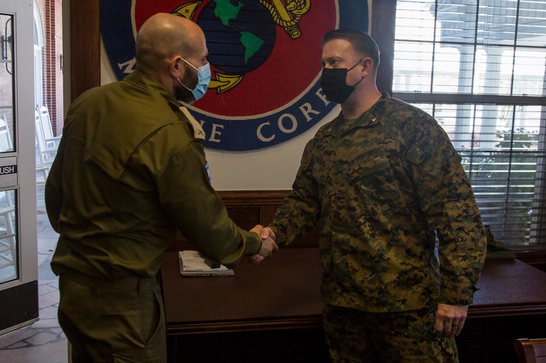 Brig. Gen. Dan Goldfus, Chief of Paratroopers and Infantry Corps for Israeli Defense Forces, is greeted by U.S. Marine Corps Lt. Col. Adam McCully, the commanding officer of Advanced Infantry Training Battalion, School of Infantry – East, during a tour from II Marine Expeditionary Force which showcased various simulation and training facilities on Camp Lejeune, N.C., Mar. 10, 2021. The purpose of the visit was for IDF leaders to develop relationships with II MEF personnel and learn about Marine Corps training, simulators, and how they are integrated into training and exercises to create fighters and leaders for the battlefield. (U.S. Marine Corps photo by Sgt. Jesus Sepulveda Torres)