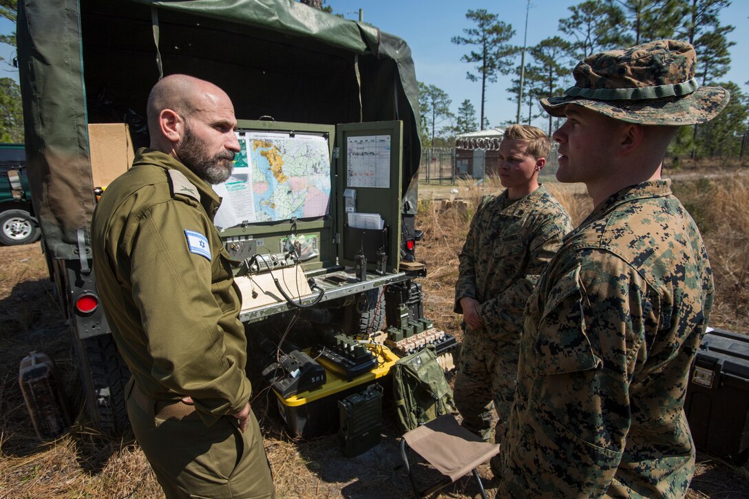 Brig. Gen. Dan Goldfus, Chief of Paratroopers and Infantry Corps for Israeli Defense Forces, speaks to U.S. Marine Corps Capt. Caleb Rich, the commanding officer of Advanced Infantry Training Company, Advanced Infantry Training Battalion, School of Infantry – East, during a tour from II Marine Expeditionary Force which showcased various simulation and training facilities on Camp Lejeune, N.C., Mar. 10, 2021. The purpose of the visit was for IDF leaders to develop relationships with II MEF personnel and learn about Marine Corps training, simulators, and how they are integrated into training and exercises to create fighters and leaders for the battlefield. (U.S. Marine Corps photo by Sgt. Jesus Sepulveda Torres)