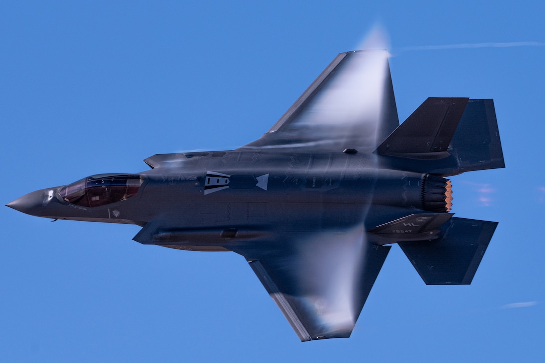 An Air Force F-35A flies in blue sky.