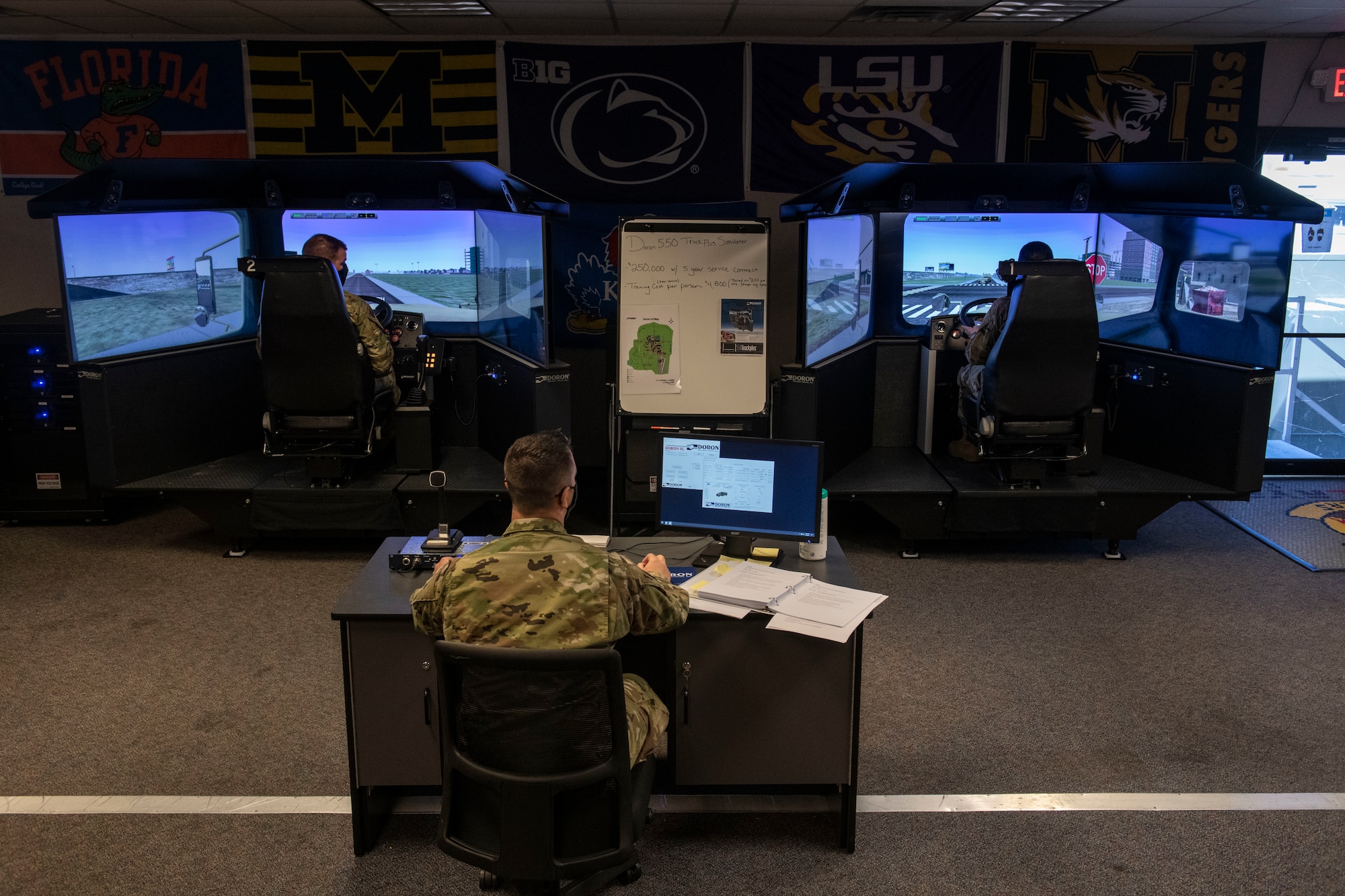 Man operates a control panel for a driving simulator