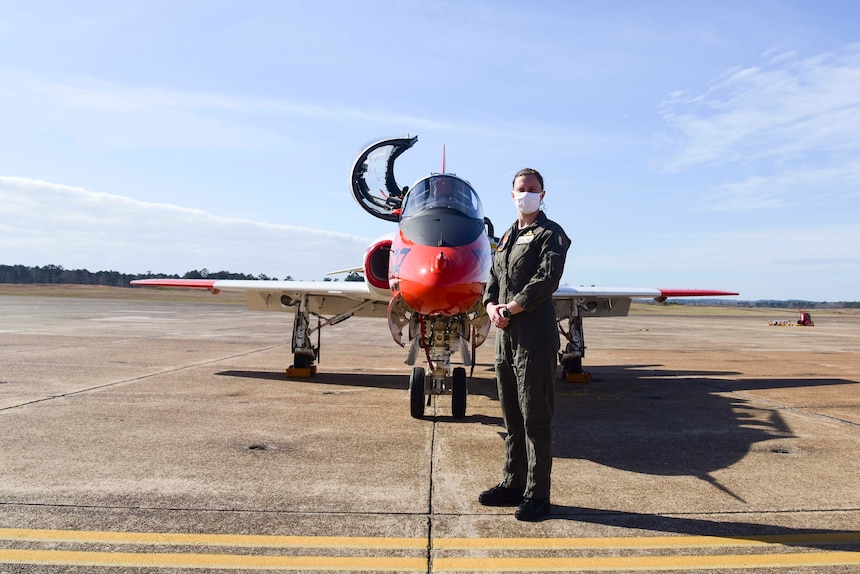 Italian navy Ensign Erika Raballo stands in front of a T-45C Goshawk jet trainer aircraft after completing her last graded flight with the "Tigers" of Training Squadron (VT) 9 qualifying her as a naval aviator at Naval Air Station Meridian, March 10.