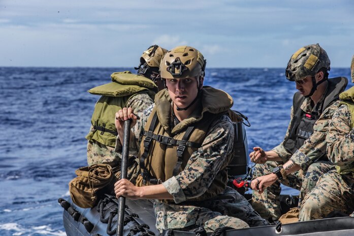 Marines with Kilo Company, Battalion Landing Team 3/4, 31st Marine Expeditionary Unit, prepare to offload in combat rubber raiding crafts from dock-landing ship USS Ashland during a Mark VI patrol boat resupply operation in the Philippine Sea, Feb. 25, 2021.