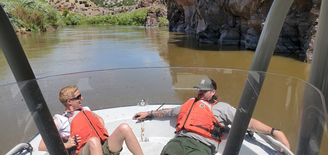 COCHITI LAKE, N.M. – Park rangers assisted in a rather unique method while on a patrol boat on the Rio Grande upstream of Cochiti Lake, May 19, 2020. The two rangers acted as counterweights to assist in the shallow water navigation.