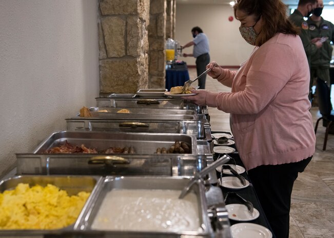 Lisamarie Mariglia, 97th Air Mobility Wing violence prevention integrator, gets food during the kick-off breakfast for the 2021 Altus Air Force Base (AFB) Annual Air Force Assistance Fund Campaign Club Altus at Altus AFB, Oklahoma, March 8, 2021. The breakfast was held to ensure key leaders around the base had all of the information for this year’s campaign. (U.S. Air Force photo by Airman 1st Class Amanda Lovelace)