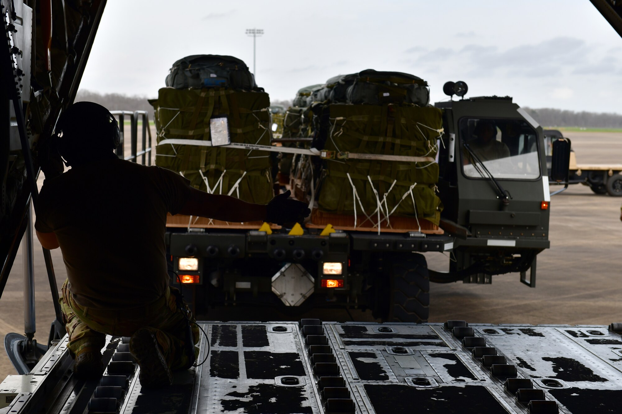 A person directs cargo onto an aircraft