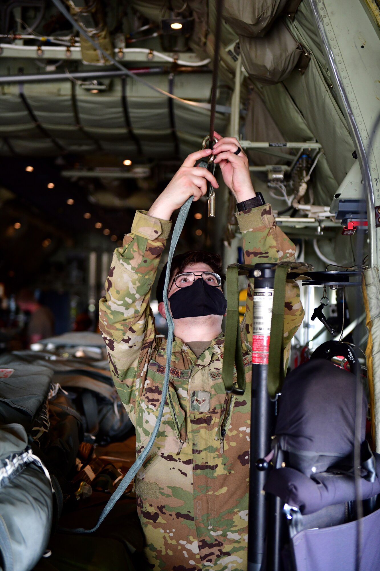 A person sets up a static parachute line