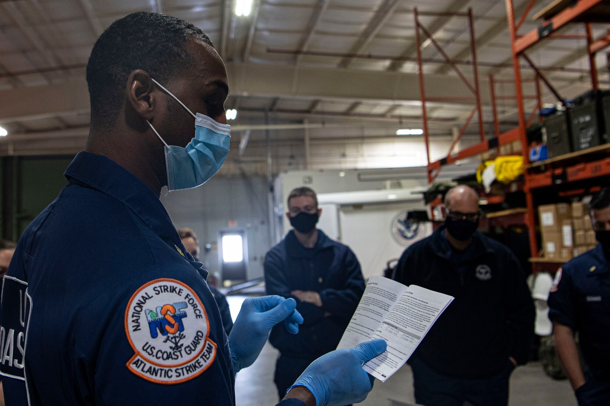 Photo of a U.S. Coast Guard Atlantic Strike Team reading instructions.