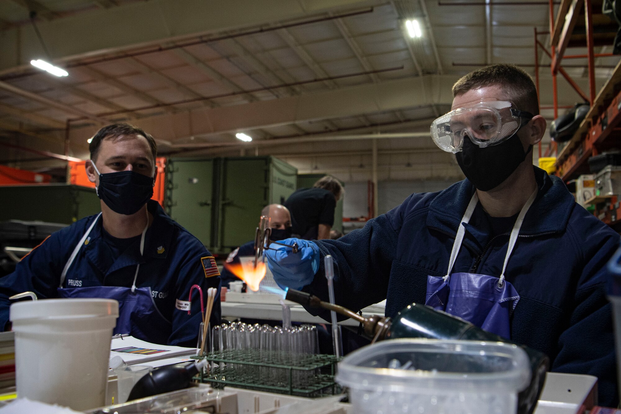Photo of a U.S. Coast Guard Atlantic Strike Team member heating a test tube.