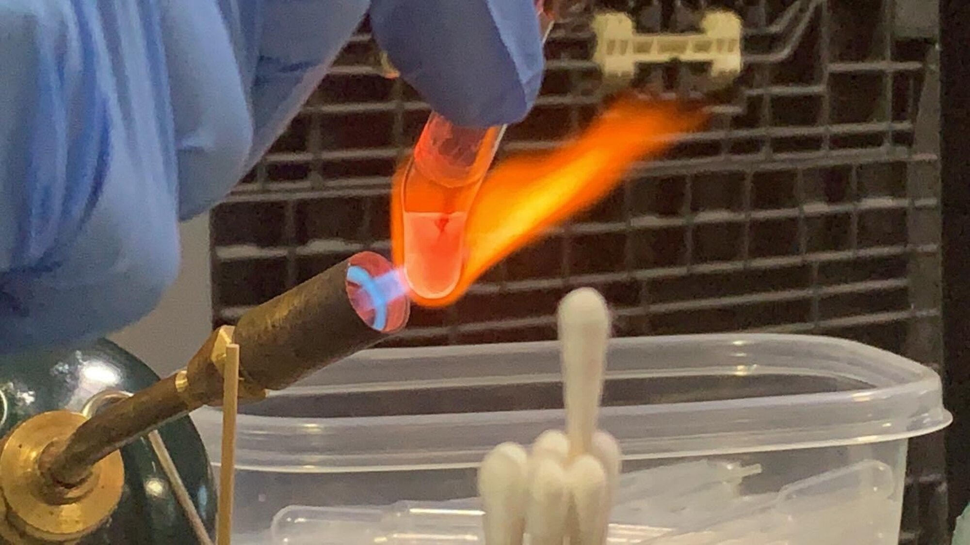 Photo a U.S. Coast Guard Atlantic Strike Team member heating a test tube.