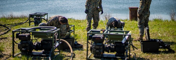 Water support technician Marines with Special Purpose Marine Air-Ground Task Force - Southern Command set up a lightweight water purification system during a command post exercise at Camp Lejeune, North Carolina, April 10, 2020. Water support technician Marines used lightweight water purification systems to purify water before providing it to the combat engineer Marines working at another site. The CPX increases readiness and challenges SPMAGTF-SC command and control, communications and timely decision-making capabilities through simulated real-world scenarios. SPMAGTF-SC will be deployed into the Southern Command area of operation to provide crisis response preparedness efforts, security cooperation training and engineering events to help strengthen relations with partner nations throughout Central and South America. (U.S. Marine Corps photo by Sgt. Andy O. Martinez)