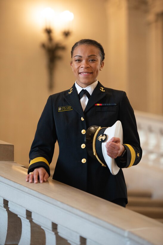 A female sailor poses for a photo.