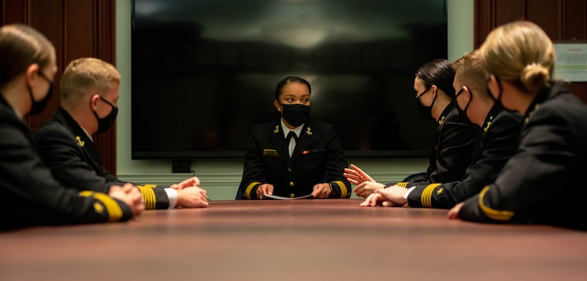 The Naval Academy’s first black female brigade commander meets with other sailors.