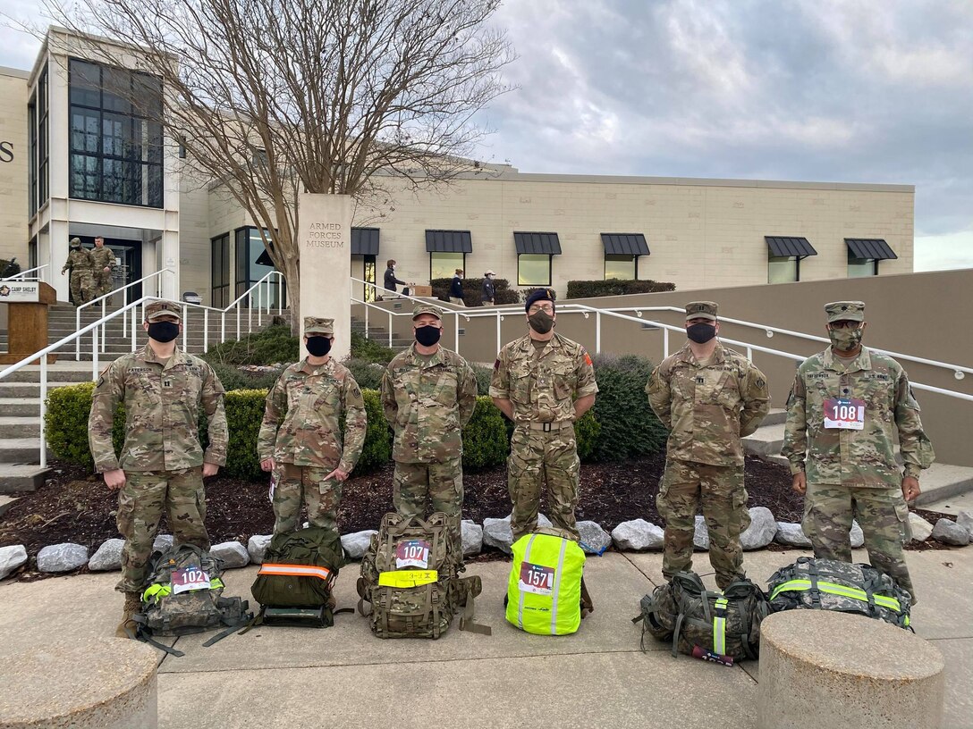 U.S. Army Engineer Research and Development Center Soldiers Capt. Jeremiah Paterson, ERDC Commander Col. Teresa Schlosser, Maj. Earl Dean, British Liaison Maj. Peter Mackintosh, Capt. Patrick Border and Lt. Col. Christian Patterson rally with 25-pound ruck sacks in advance of the 18.6-mile Norwegian Foot March at Camp Shelby Joint Forces Training Center, near Hattiesburg, Miss., March 6, 2021. (U.S. Army Corps of Engineers photo)