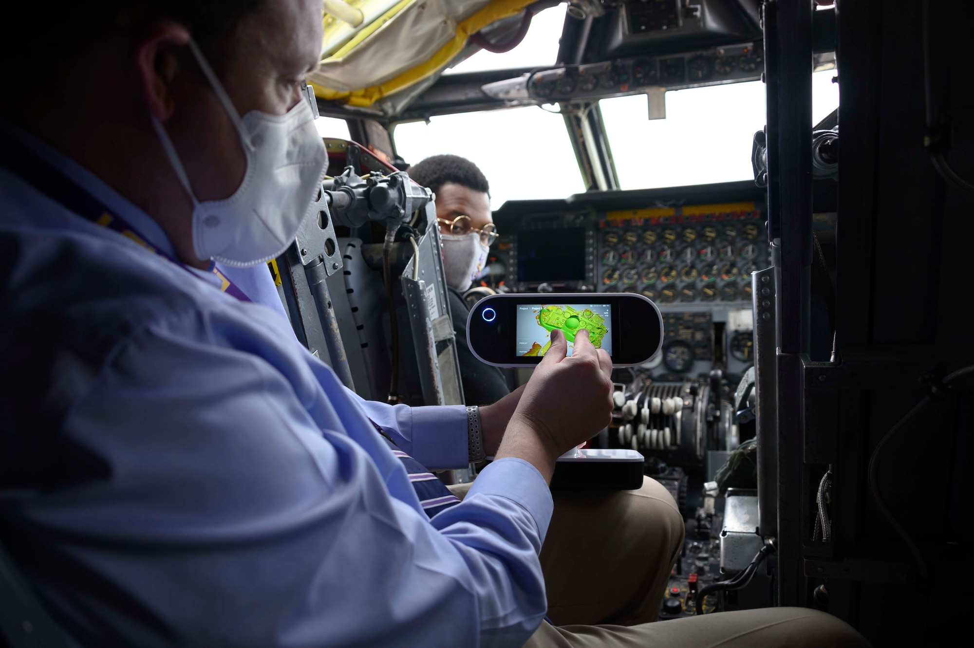 Photo of a person using a 3D scanner in cockpit of a B-52 Stratofortress.