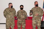 U.S. Air Force Brig. Gen. Ray Shepard, the Assistant Adjutant General- Air for West Virginia, left, and Command Chief Master Sgt. David Stevens, West Virginia Air National Guard Command Chief, right, present Airman 1st Class Pujaba Chudasama, with the James Kemp McClaughlin trophy during the 167th Airlift Wing’s Outstanding Airman of the Year ceremony March 7, 2021.