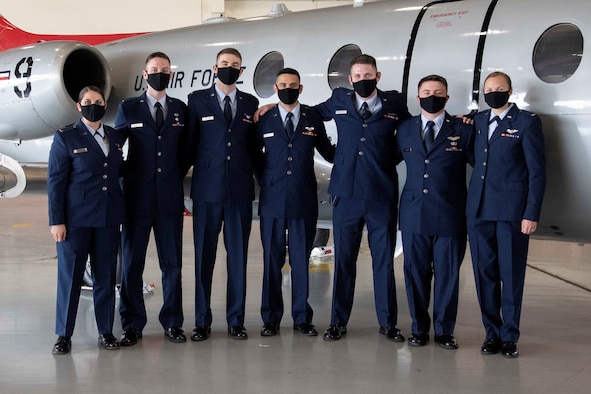 Graduates from the first-ever “Accelerated Path to Wings” class gather in front of a T-1 Jayhawk aircraft after receiving their pilot wings March 12, 2021 at Joint Base San Antonio-Randolph, Texas. Accelerated Path to Wings is part of Air Education and Training Command's pilot training transformation program, a two phase T-1 only pilot training tract. The 99th Flying Training Squadron is responsible for executing the seven month training mission that culminates with students earning their pilot wings.