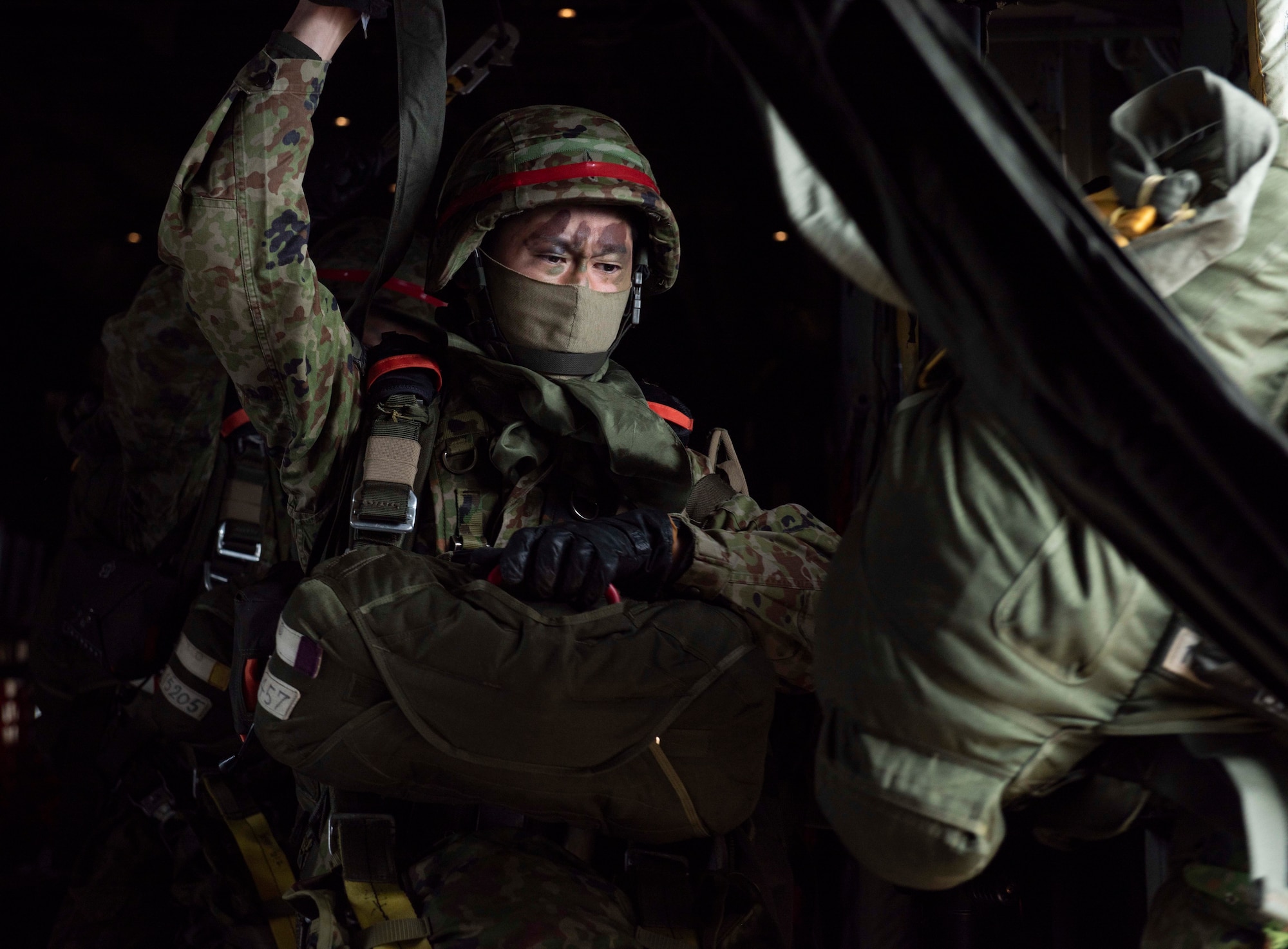 A Japan Ground Self Defense Forces paratrooper jumps out of a C-130J Super Hercules C-130J Super Hercules assigned to the 36th Airlift Squadron during an Airborne 21 exercise