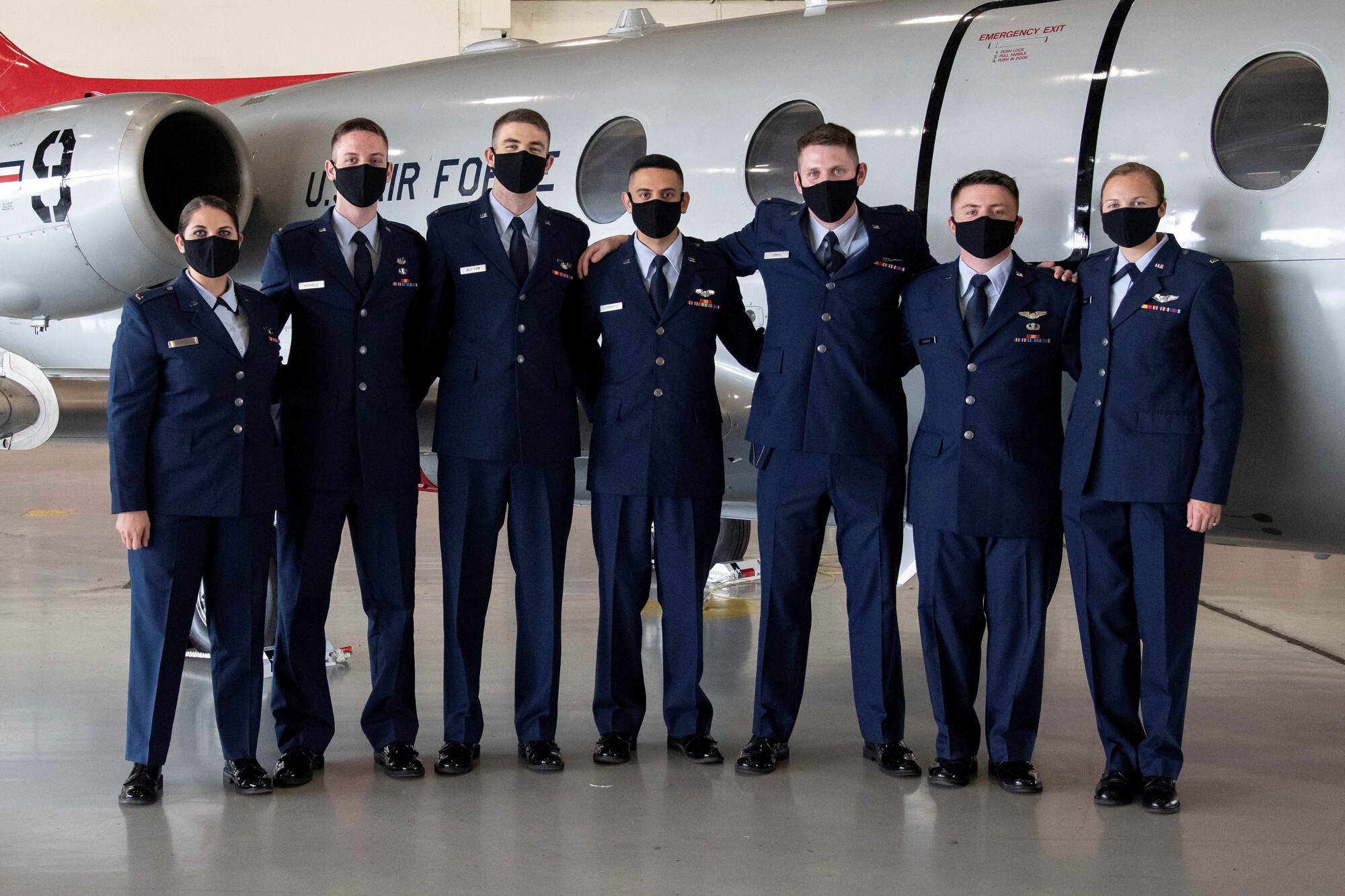 Graduates from the first-ever “Accelerated Path to Wings” class gather in front of a T-1 Jayhawk aircraft after receiving their pilot wings March 12, 2021 at Joint Base San Antonio-Randolph, Texas. Accelerated Path to Wings is part of Air Education and Training Command's pilot training transformation program, a two phase T-1 only pilot training tract. The 99th Flying Training Squadron is responsible for executing the seven month training mission that culminates with students earning their pilot wings.