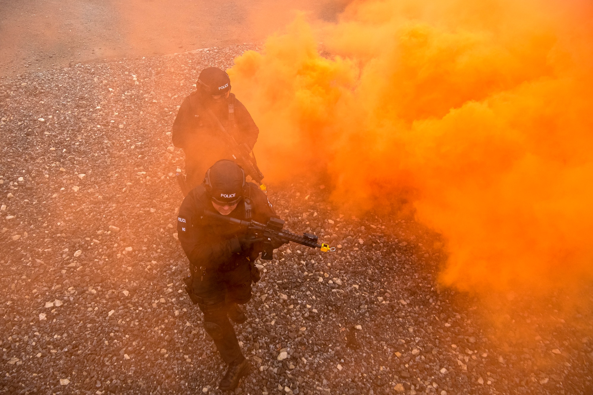 Policemen from the Northamptonshire Police Department, advance their positions during a field training exercise at RAF Croughton, England, Mar. 3, 2021. The NHPD utilized the 422d Security Forces Squadron training complex to help strengthen their tactics and techniques. Events like this help strengthen the local partnership between the 422d SFS and the NHPD. (U.S. Air Force photo by Senior Airman Eugene Oliver)