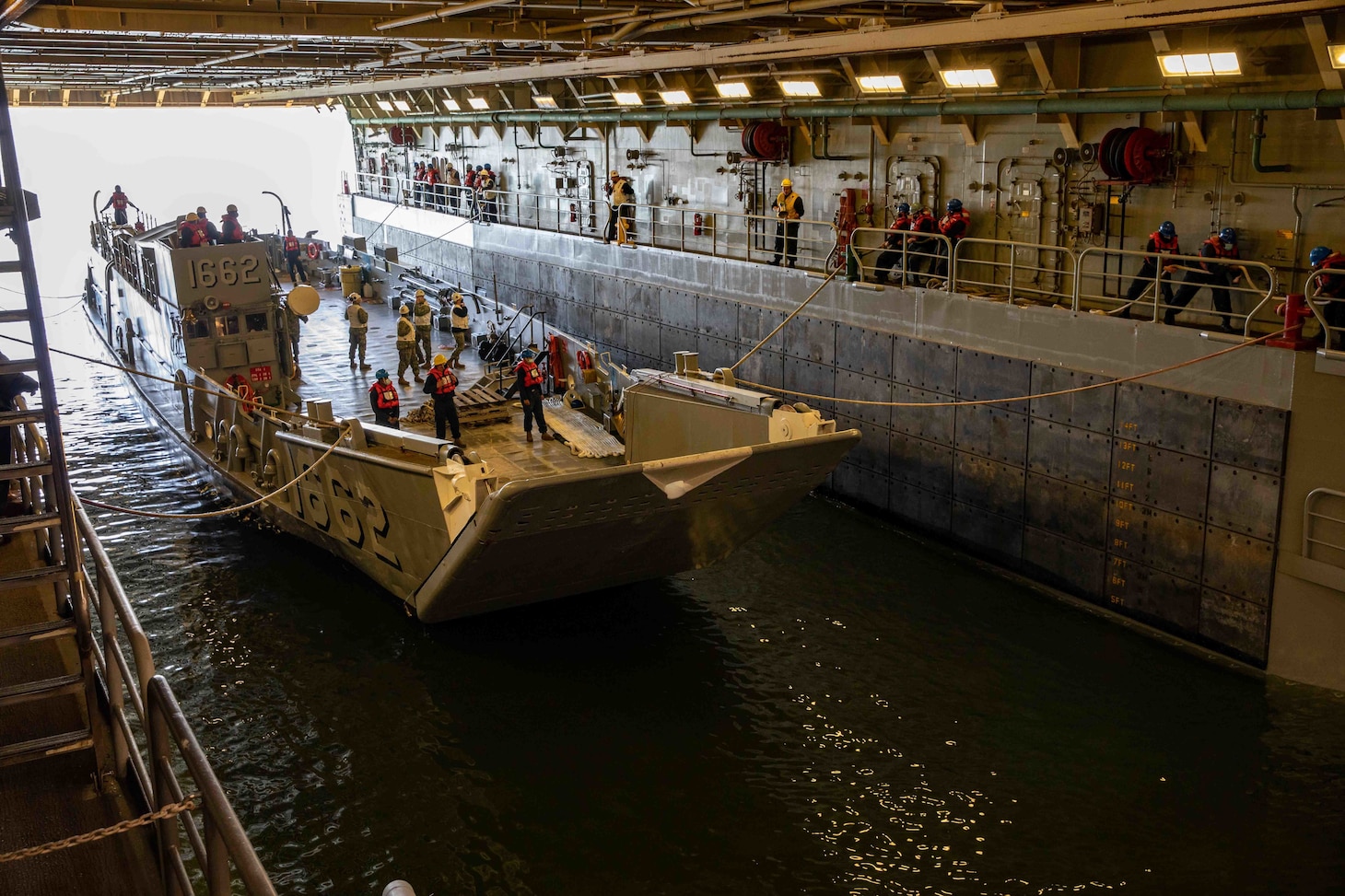 Sailors assigned to the San Antonio-class amphibious transport dock ship USS Arlington (LPD 24) conduct well deck operations with Landing Craft Utility (LCU 1662), March 8, 2021.