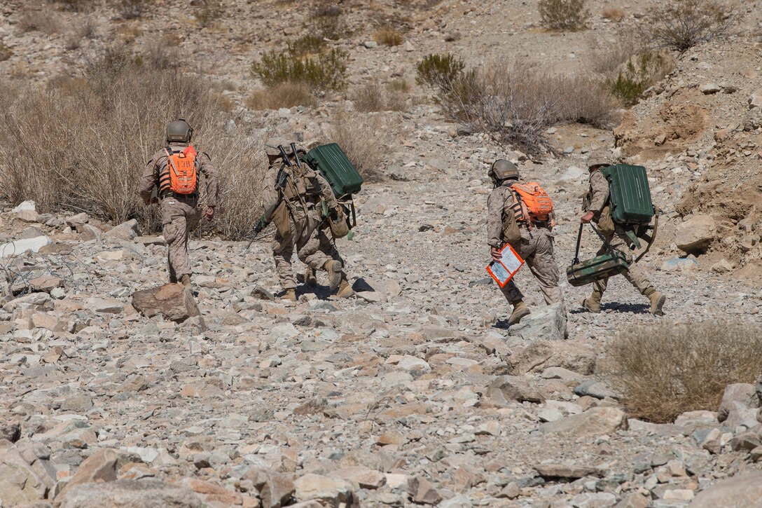 U.S. Marines with Company E, 2nd Battalion, 7th Marines Regiment, 1st Marine Division, transport multiple Anti-Personnel Obstacle Breaching Systems to an objective during Integrated Training Exercise 2-21 at Marine Corps Air Ground Combat Center, Twentynine Palms, California, March 5, 2021. Range 400 provides platoon and company sized elements with live-fire training attacking an enemy strongpoint. (U.S. Marine Corps photo by Lance Cpl. Gustavo Romero)