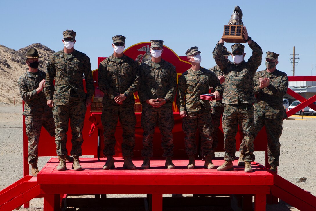 U.S. Marines, a team with Marine Air Ground Task Force, Training Directorate receive the “San Diego Bear” trophy in the Marine Corps Marksmanship Competition West at Marine Corps Air Ground Combat Center, Twentynine Palms, California, March 5, 2021. The Marine Corps Marksmanship Competition West is one of four marksmanship competitions in the Marine Corps that gathers Marines to improve and test their skills while competing. (U.S. Marine Corps photo by Lance Cpl. Jacquilyn Davis)