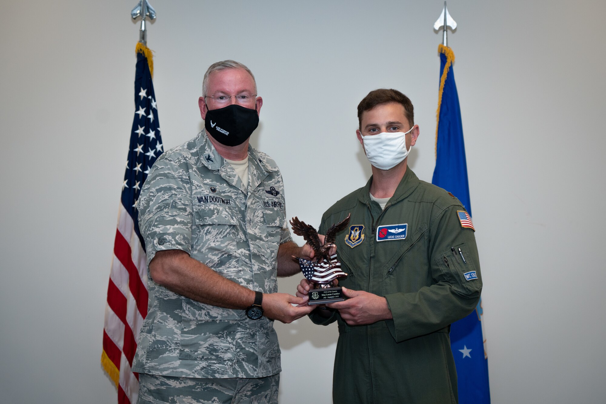 Maj. Lucas Caulder with the 403rd Wing receives the Field Grade Officer of the Quarter Award during a commander’s call at Keesler Air Force Base, Biloxi Mississippi, March 13, 2021 . Top performers from the wing were recognized for their outstanding work throughout fourth quarter of 2020. (U.S. Air Force photo by Staff Sgt. Shelton Sherrill)
