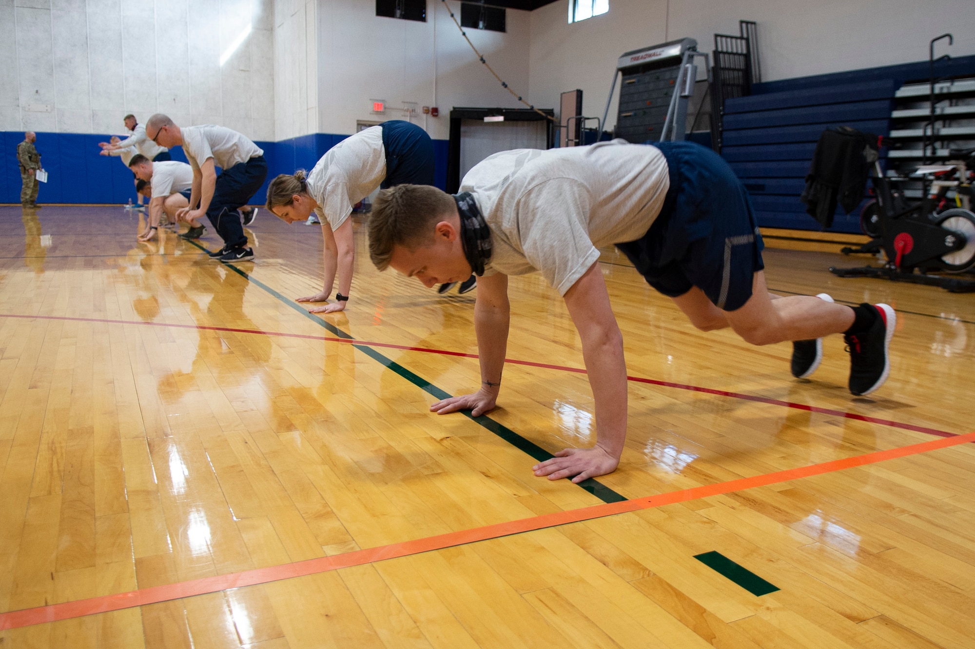 Senior Airman David Halbur, 434th Civil Engineer Squadron engineer assistant, and others from Grissom Air Reserve Base, Ind. perform modified burpees as part of physical fitness testing assessment, March 13, 2021. Airmen volunteered to test new components to the Air Force fitness assessment and gave their feedback as part of a pilot program here. (U.S. Air Force photo by Staff Sgt. Michael Hunsaker)