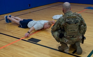 Tech. Sgt. Jordan Edwards, 434th Security Forces Squadron stan eval, performs a two-minute hand release push-up at Grissom Air Reserve Base, Ind., March 13, 2021. Airmen from Grissom volunteered to participate in the Air Force pilot program to test the new components of the physical fitness assessment. (U.S. Air Force photo by Staff Sgt. Michael Hunsaker)