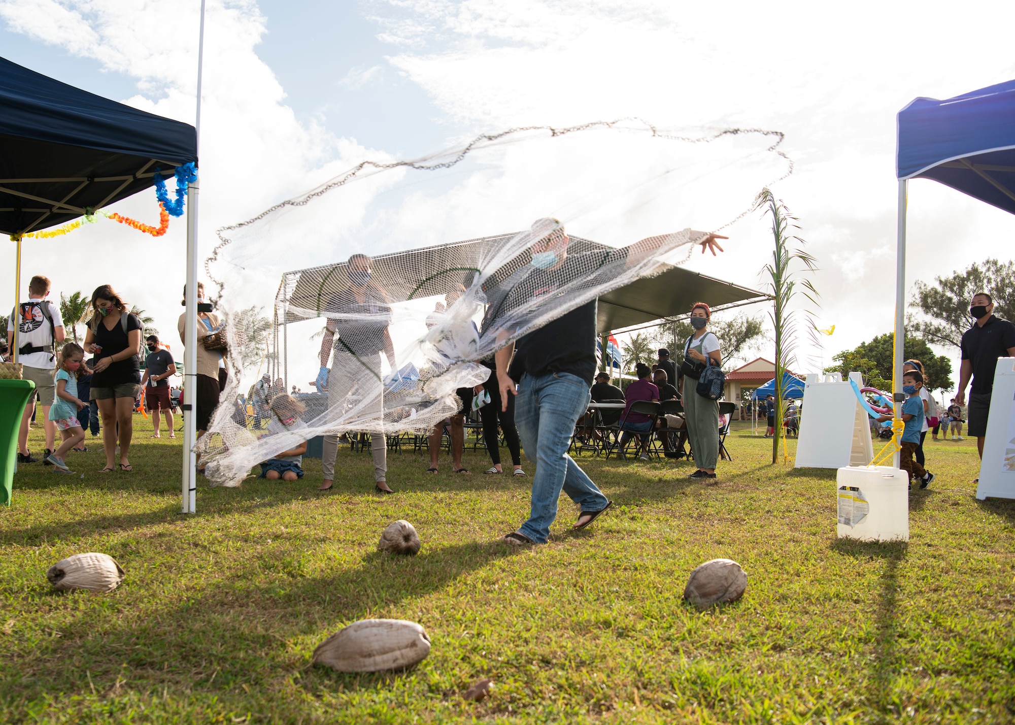 A participant throws a cast net over coconuts during the Tåotåo Guåhan event at Arc Light Memorial Park at Andersen Air Force Base, Guam, March 13, 2021. In honor of CHamoru Month, the Andersen AFB community hosted an event to celebrate the island’s indigenous culture and heritage with members of the base and local residents in attendance. (U.S. Air Force photo by Senior Airman Aubree Owens)
