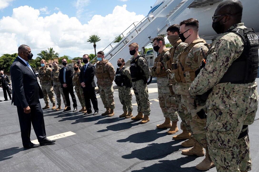 Defense Secretary Lloyd J. Austin III speaks to a line of service members.