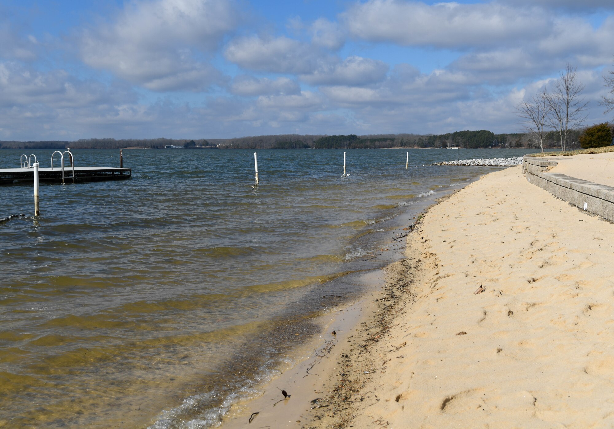 Waves of Woods Reservoir lap at sand in front of a newly-built wall for the beach area of the Arnold Lakeside Complex, Feb. 22, 2021, at Arnold Air Force Base, Tenn. (U.S. Air Force photo by Jill Pickett)