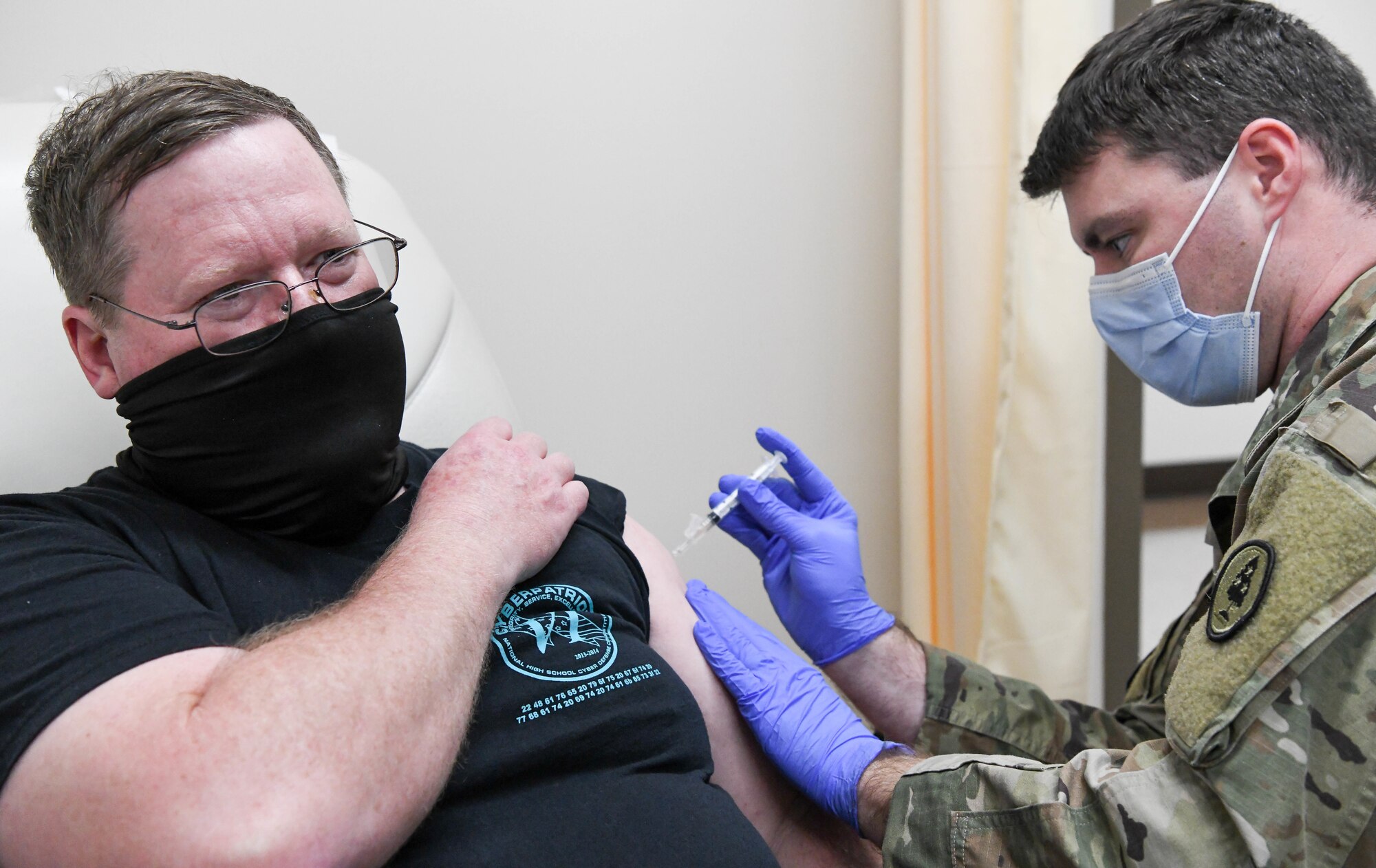 Sgt. Dillon Henderson with the Tennessee Army National Guard administers a COVID-19 vaccine to Michael Glennon, an Arnold Engineering Development Complex team member, at Arnold Air Force Base, Tenn., Feb. 23, 2021, at the Medical Aid Station on base. (U.S. Air Force photo by Jill Pickett)
