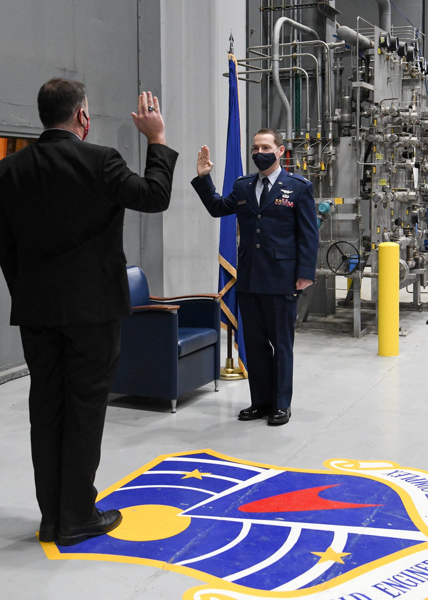 Brian Knauf, retired Air Force lieutenant colonel, left, administers the oath of office to his brother, newly-promoted Lt. Col. Michael Knauf during a promotion ceremony, March 1, 2021, at Arnold Air Force Base, Tenn. (U.S. Air Force photo by Jill Pickett)